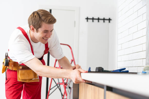 istock craftsman installs hob in kitchen. Household Appliance Installation Services Concept. 1738522449