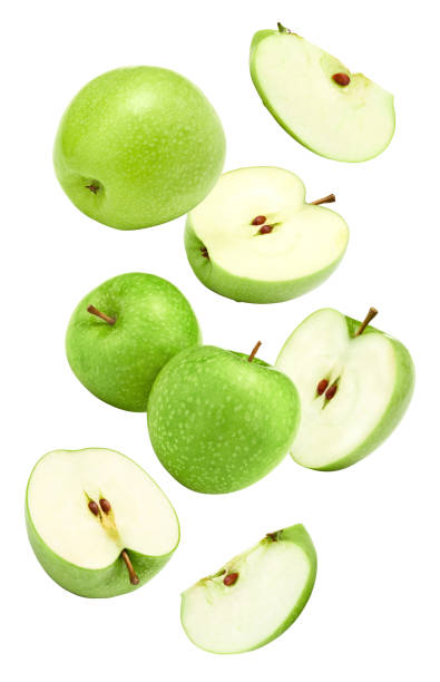 istock flying green apples isolated on white background. clipping path 1738525144