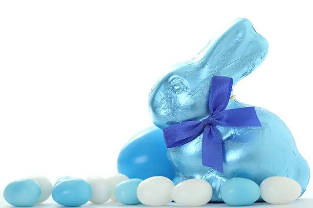 Blue easter bunny with jellybeans on white background