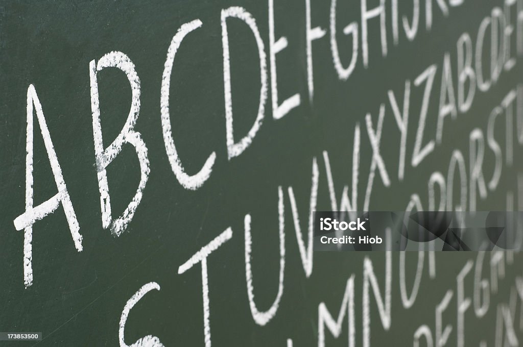 ABC letters on a blackboard ABC letters written on a green blackboardshallow depth of field Alphabetical Order Stock Photo