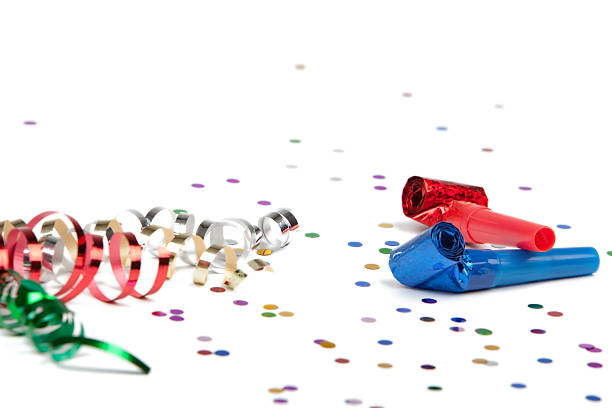 Party ribbon confetti and horn blower on white background stock photo