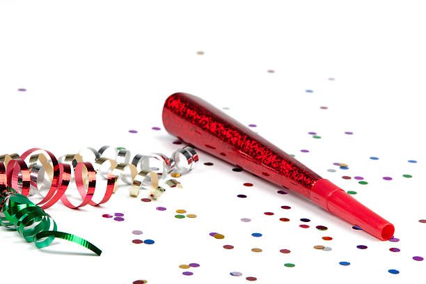 party ribbon, confetti and horn blower isolated on white stock photo