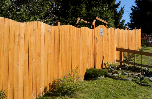 A new wooden fence with a wave design