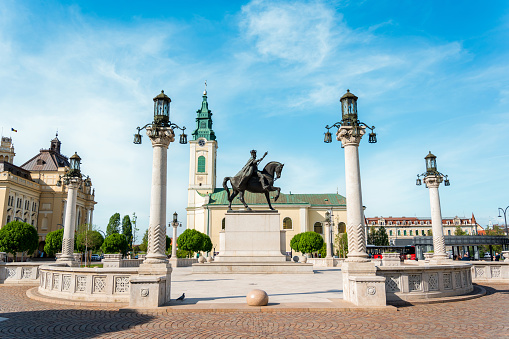 oradea, romania - may, 2023: view of the king ferdinand i statue located on the unirii square. buildings in classic style around