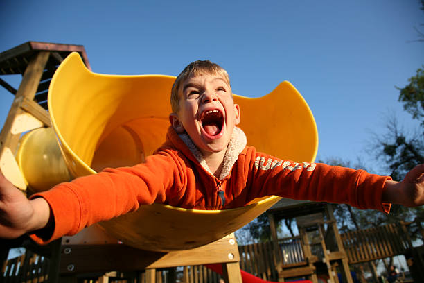 Playground excitement in a young boy.