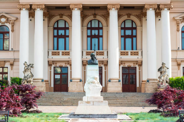 oradea, romania - may, 2023: view of the king ferdinand i statue located on the unirii square. buildings in classic style around