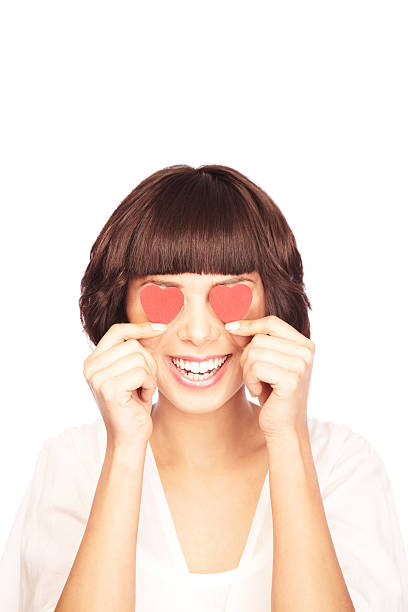 istock Attractive Young Brunette with Red Hearts Over Her Eyes 173857132