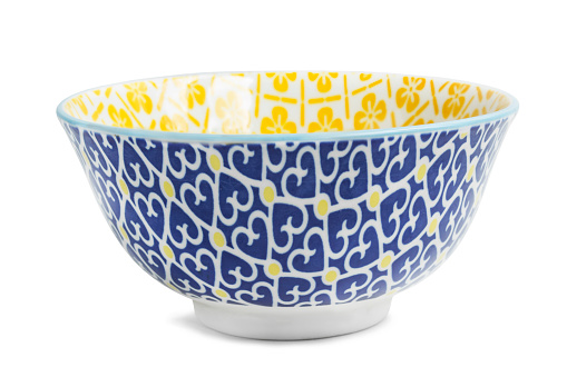 Blue and yellow ceramic bowl isolated on white background