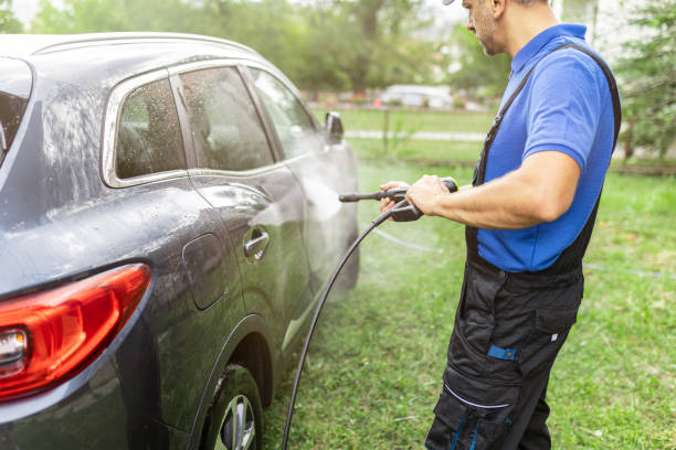 istock Man washing his car in the backyard by using water pressure washer 1738581692