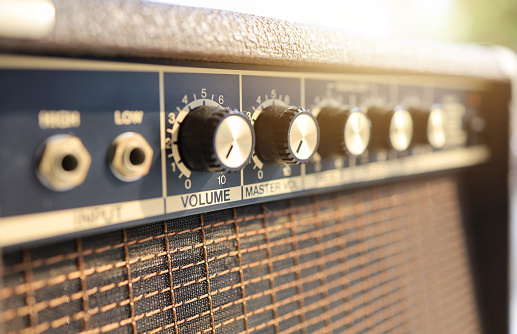 An amplifier cabinet which has gold hardware.