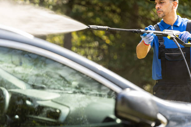 istock Man washing his car in the backyard by using water pressure washer 1738585333