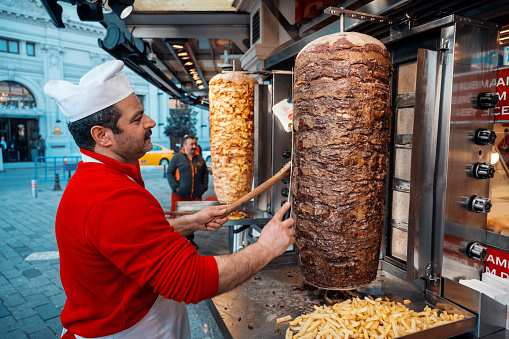 istanbul, turkey - march, 2023: a street food cook making a kebab