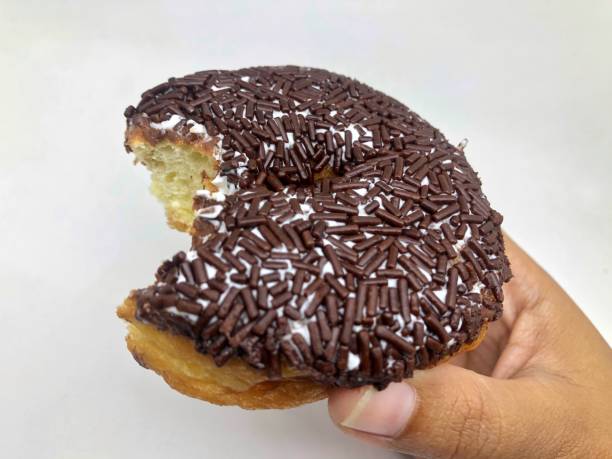 donut bread with bitten chocolate topping isolated on white