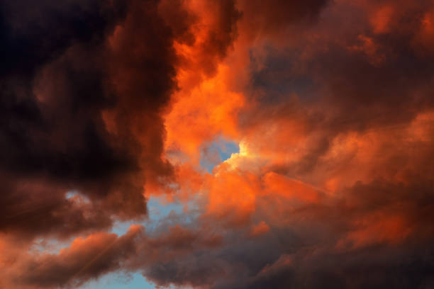 istock Sun rays beaming through moody clouds at dramatic sky in summer sunset 1738599329