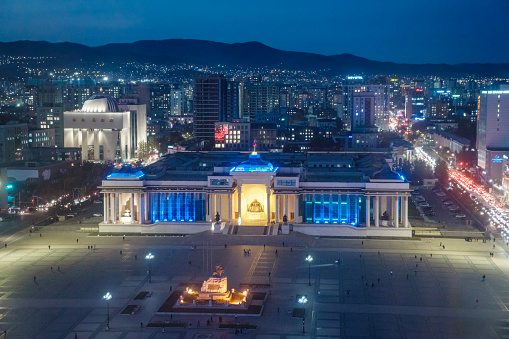 Elevated skyline photo with Sukhbaatar Square surrounded by hotels, museums and various other buildings in central Ulaanbaatar, Mongolia at dusk.