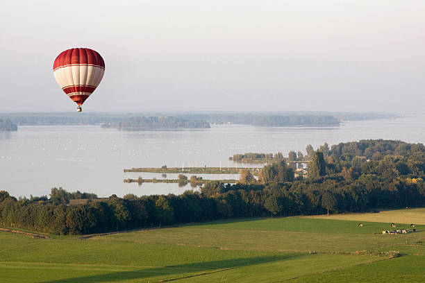 Hot Air Balloon gently floating in the sky in late afternoon