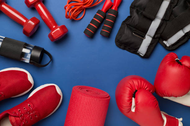 istock Red sport equipment on color background, top view 1738617759