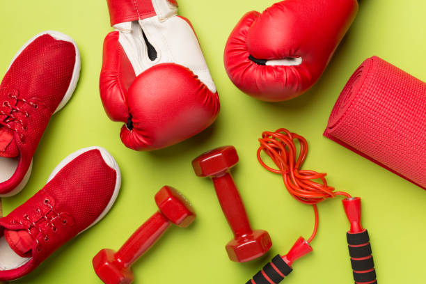 istock Red sport equipment on color background, top view 1738617762