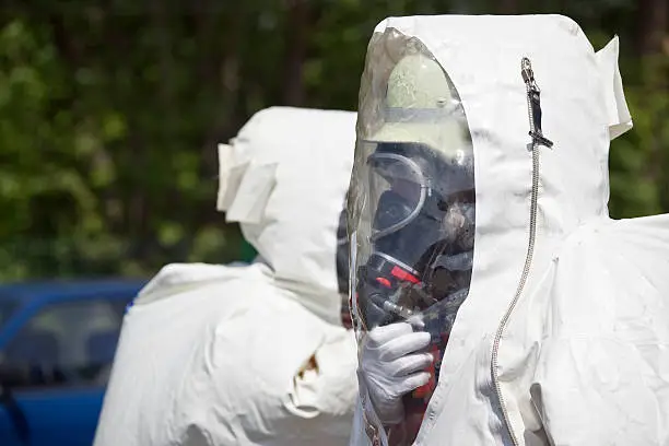 Two unrecognizable men in protective gear. The inflatable gear protects against contamination with radioactive particles, against Alpha radiation and partially against Beta radiation. Adobe RGB for better color reproduction.