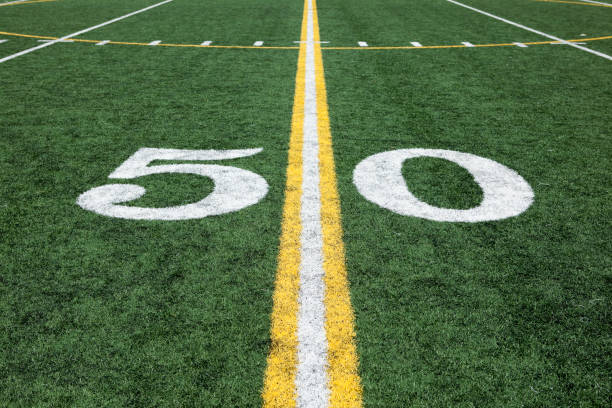 istock Football stadium 50 yard line artificial grass and markings 173862406