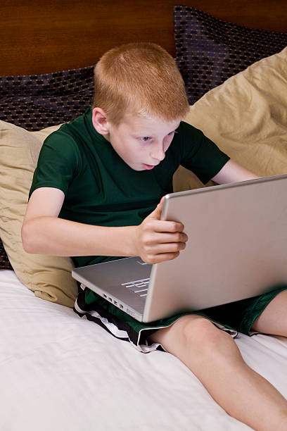 Little boy playing on the computer stock photo