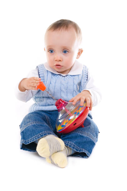 Baby with rolling toy on the white background stock photo