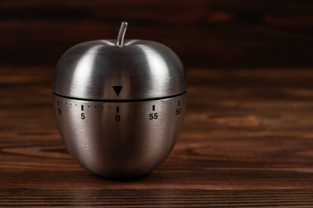 istock Metal apple kitchen timer on wooden background 1738639834