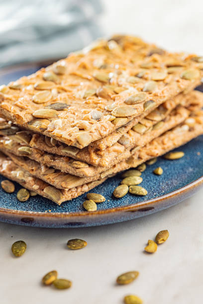 istock Knackebrot with sesame seeds. Wholegrain crispbread on plate on kitchen table. 1738641111