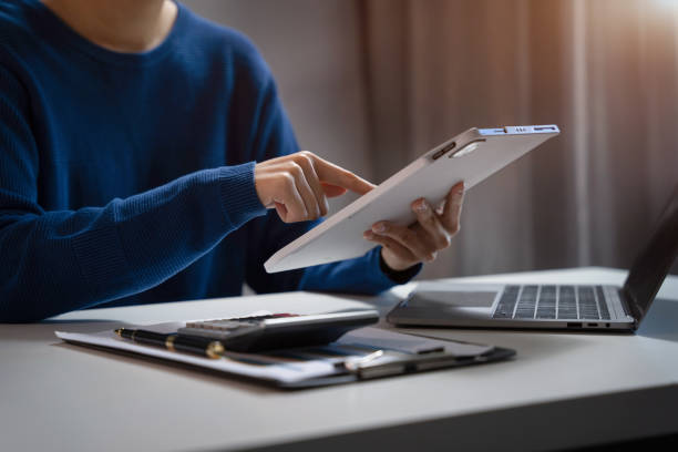 istock Businesswoman working on tablet and laptop computer, searching working in office. 1738641658