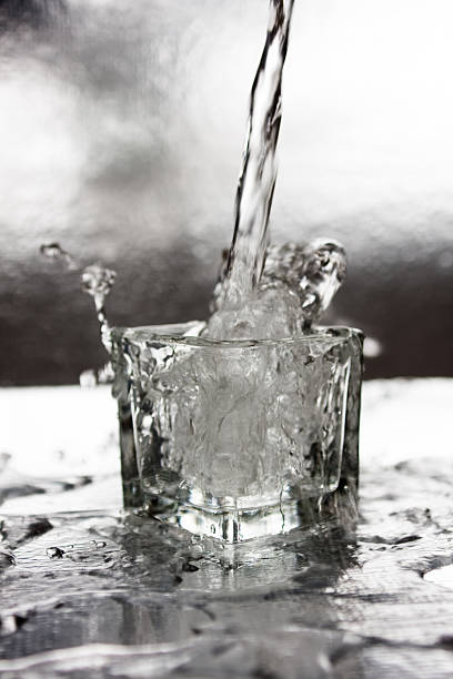 water pouring into cup stock photo