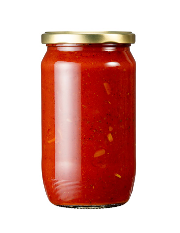 A jar of tomato sauce placed against a white background. Sealed container.