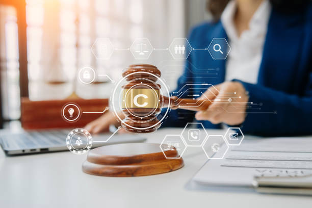 istock Copyright or patent concept, Person hand using laptop computer, tablet and smartphone with virtual screen copyright icon trademark, Creation ownership against piracy. 1738644493