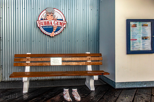 Santa Monica, USA; January 16, 2023: The famous seat, Nike sneakers and Bubba Gump seafood restaurant owned by Forrest Gump on the Santa Monica Pier in the US state of California.