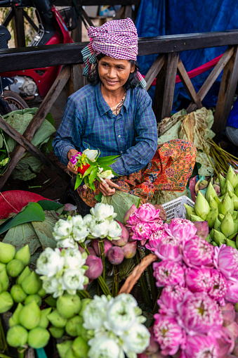 Cambodian woman selling flowers on a local market in Siem Reap, Cambodia