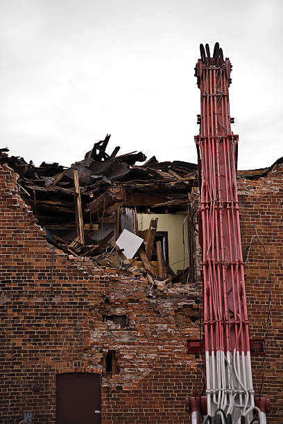 istock A Building being demolished using heavy industrial equipment 173865237