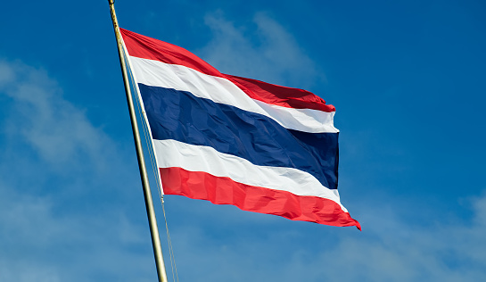 Thailand flag waving with blue sky in background