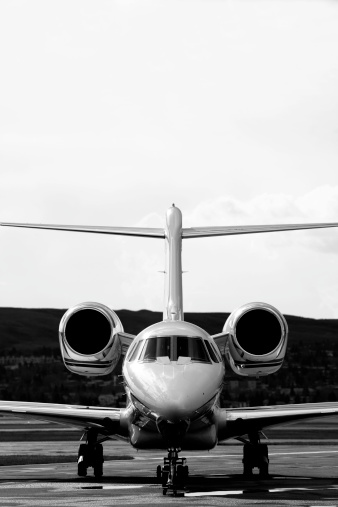 Black and white corporate jet with copyspace above.