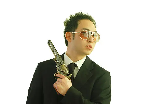 Asian man holding a pistol.Similar Shots: