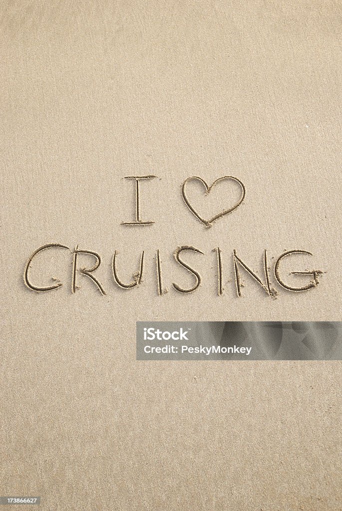 I Love Cruising Message in Sand Simple message in the sand says I Love Cruising with copy and design space above and below Beach Stock Photo