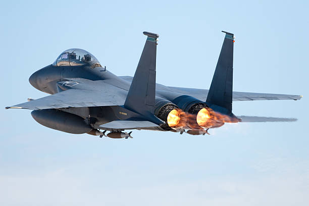 Fighter jet in flight with afterburners activated stock photo