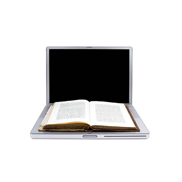 istock Open antique book on a modern laptop 173867362