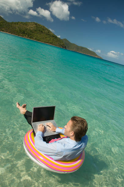 istock Relaxed Businessman Working Floating and Typing Tropical Waters 173867549