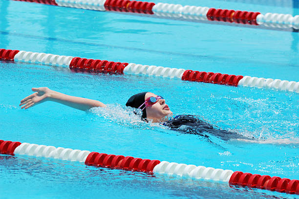 istock Young Girl Backstroke Swimmer in Race 173867682