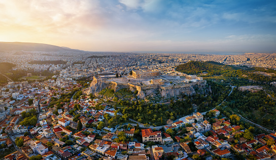 Elevated, panoramic view of the skyline of Athens, Greece, with Acropolis, the Parthenon Temple and the old town Plaka during golden sunrise