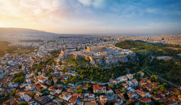 Elevated, panoramic sunrise view of the skyline of Athens, Greece Elevated, panoramic view of the skyline of Athens, Greece, with Acropolis, the Parthenon Temple and the old town Plaka during golden sunrise plaka athens stock pictures, royalty-free photos & images
