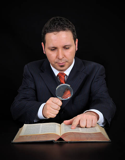 businessman is using the magnifying glass stock photo