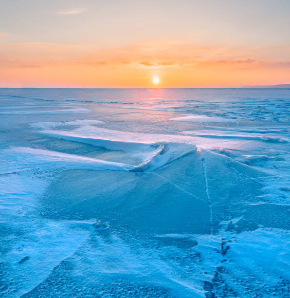 istock A frozen surface of ice with snow intersected by many cracks. 1738696583