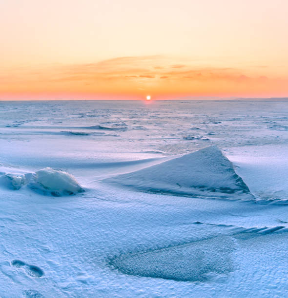 istock Snowdrifts on the ice surface during sunset. 1738696623
