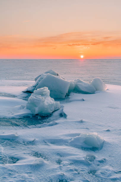 istock Snowdrifts on the ice surface during sunset. 1738696624