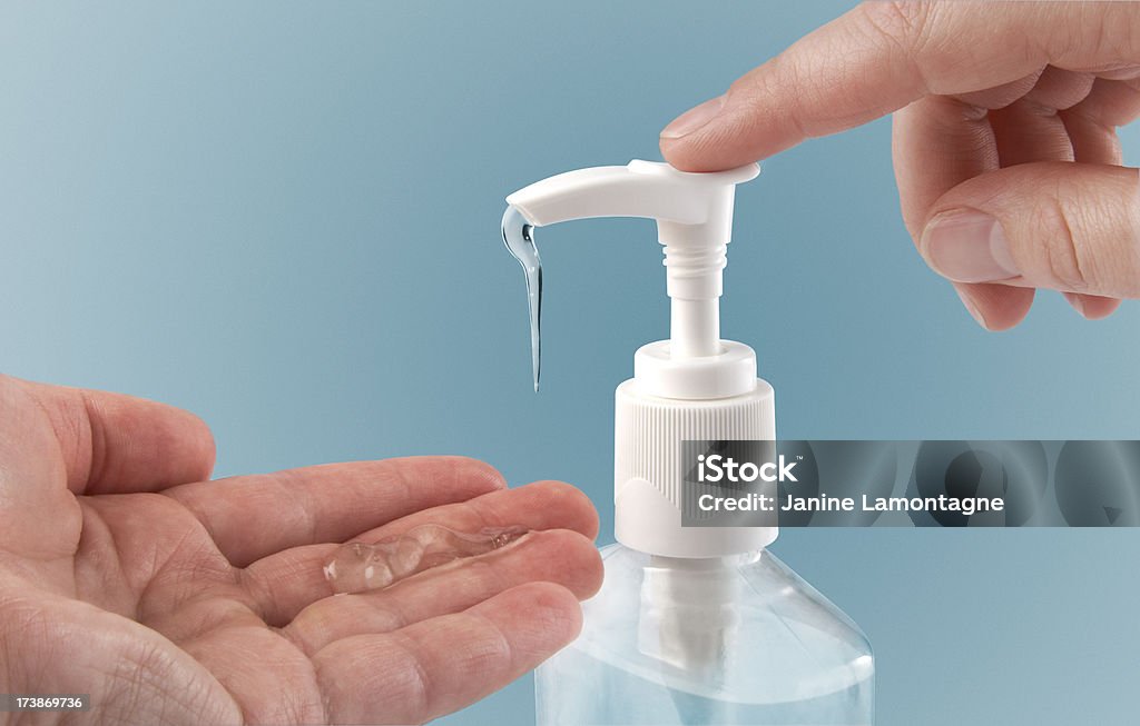 Photograph of a finger pumping sanitizer onto hand Pumping hand sanitizer into hand. Hand Sanitizer Stock Photo